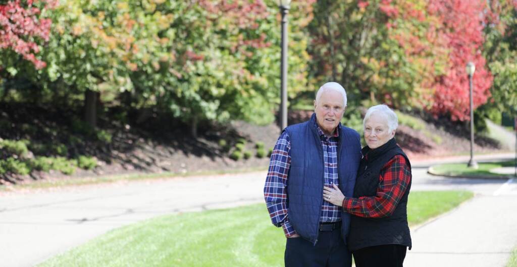 Smiling couple standing together outdoors